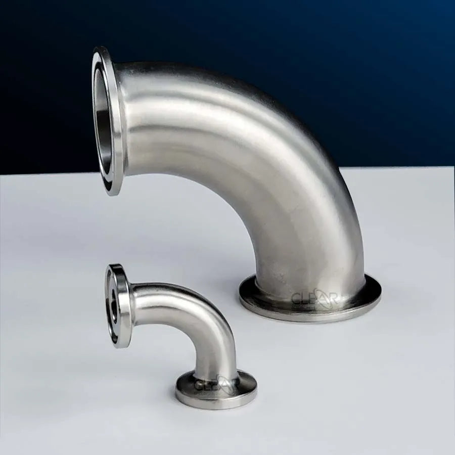 several tri-clamp elbow fittings on a table